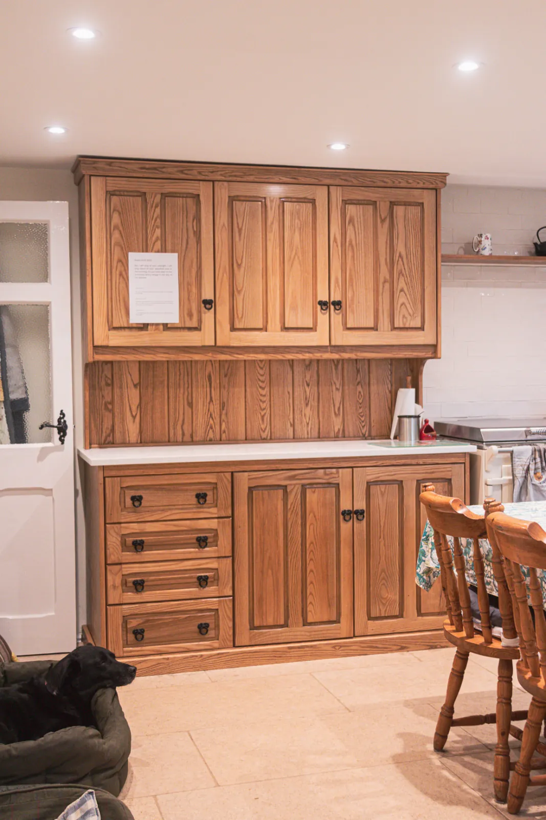 Bespoke solid oak Welsh dresser with panelled doors and drawers in a cottage kitchen