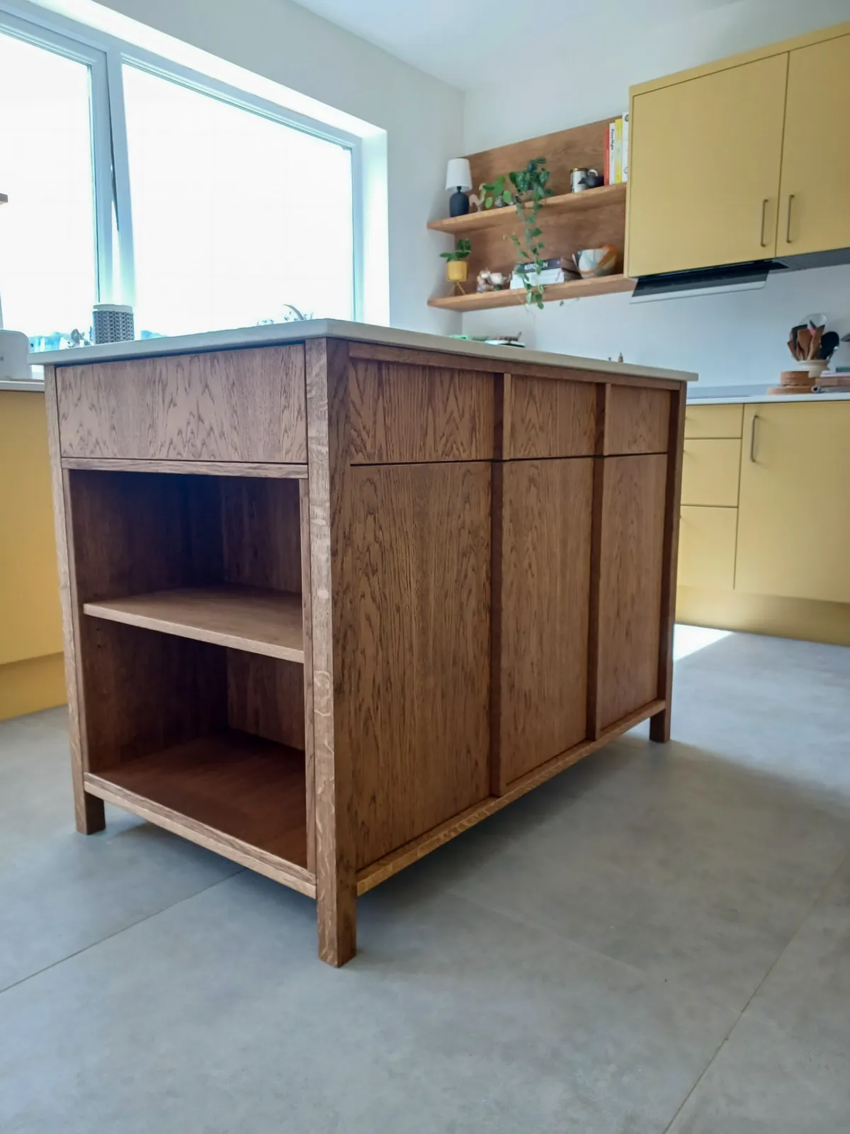 Bespoke oak kitchen island with open shelves and panelled cupboard doors